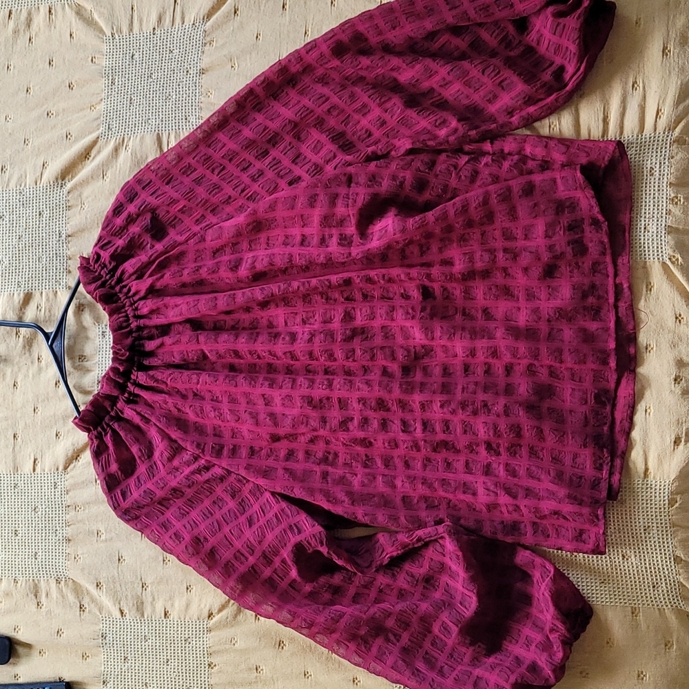 Maroon colored shirt.